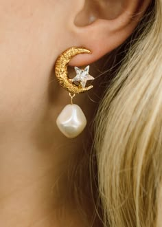 The Lune Earrings feature a gold moon with carefully carved detail. These earrings celebrate the inspiration of the moon as a symbol of femininity, wisdom, and spiritual connection. A tiny crystal star is nestled in the crook of the moon, and a baroque-style pearl adds a feminine touch. Explore more styles from The Celestial Edit. Luxury Hair Accessories, The Bling Ring, Jennifer Behr, Gold Moon, Crystal Stars, Spiritual Connection, Pearl Earrings Dangle, Discount Sale, Baroque Fashion