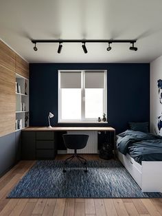 a bedroom with a bed, desk and bookshelf next to a large window