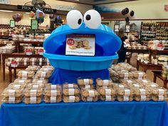 a display in a store filled with lots of cookies and crackers on top of a blue table