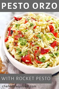 pasta salad with tomatoes, broccoli and pesto in a white bowl