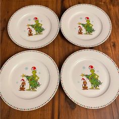 four white plates with christmas designs on them