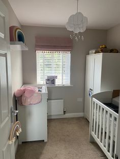 a baby's room with a crib, dresser, and bed in it