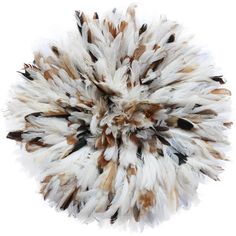 a white and brown area rug with many feathers on the top, in front of a white background