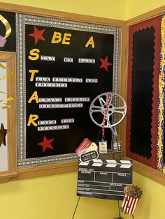 a blackboard with red, white and blue stars on it next to a movie projector