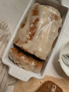 a loaf of bread with icing in a container