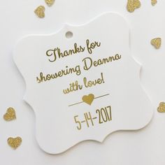 a white ornament with gold hearts on it and the words, thanks for showering donna with love