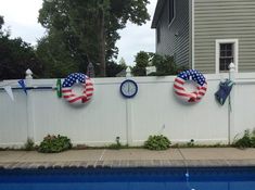 the american flag wreaths are on the fence by the pool