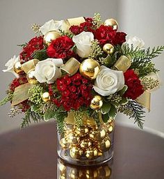 a vase filled with lots of red and white flowers