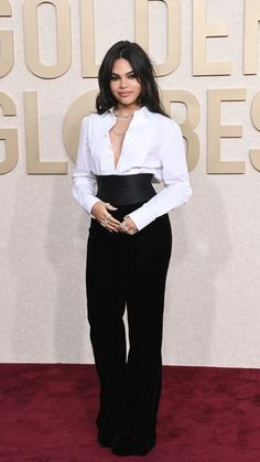 an image of a woman in black and white at the golden globes awards red carpet