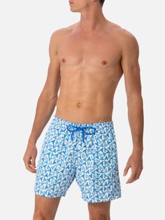 Man Lighting mid-length swim shorts are designed with a lightweight fabric that dries quickly, earning their name Lighting. The elasticized waistband and drawstring closure with branded terminals ensure a comfortable fit, while the branded eyelets are strategically placed to drain water and prevent the shorts from ballooning. Featuring side pockets with French seams and a back patch pocket with a magnetic closure, these swim shorts are both practical and stylish. Additionally, there's a small in Beachwear Bottoms With Elastic Waistband For Travel, Summer Shorts For Travel, Summer Travel Bottoms Short Length, Summer Travel Bottoms In Short Length, Summer Travel Shorts, Bermuda Swim Trunks With Elastic Waistband For Beach, Bermuda Beachwear Bottoms With Elastic Waistband, Beachwear Bottoms For Travel And Beach Season, Beachwear Bottoms For Beach Season Travel