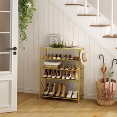 there is a shelf with shoes and umbrellas on it in front of the stairs