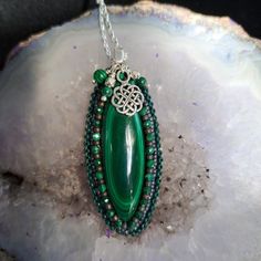 Malachite with a Celtic accent. This is a beauty of a stone and has been accented perfectly. Wrapped with small faceted malachite beads, malachite drops and a sterling silver Celtic charm, all hanging from a delicate Sterling Silver 20" box chain. Includes a 2" sterling extender to make it the perfect length for your occasion. Perfect for any occasion. The Malachite cab has been joined with bead embroidery to make a nice piece of wearable art. I like to include seed beads, glass, leather, stones Handmade Elegant Malachite Beaded Necklaces, Spiritual Beaded Malachite Jewelry, Spiritual Malachite Beaded Jewelry, Bohemian Malachite Jewelry With Polished Beads, Green Spiritual Beaded Necklaces With Stones, Spiritual Green Beaded Stone Necklaces, Green Spiritual Beaded Necklace With Stones, Bead Embroidery, Box Chain