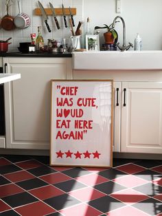 a sign that is on the floor in a kitchen