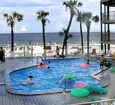 an outdoor swimming pool with people in it