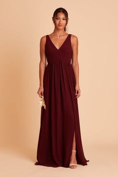 a woman in a long burgundy dress