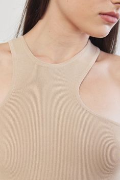 A close fit ribbed top featuring an asymmetrical neckline. Made from a knitted fabric with fully fashion finishes. Wear yours any bottom from denim to skirt. 55% Viscose 42% Nylon 3% Spandex Color:﻿ Beige Care: Hand wash recommended in cold water. Do not bleach. Do not tumble dry. Do not wring. Dry flat. Dry clean, any solvent except trichloroethylene. Fits true to size, take your normal size Model wears: S Model's fit:﻿ 1.73 cm Waist 60 cm Hips 91 cm Bust 80 cm Casual Ribbed Bodycon Top, Trendy Ribbed Bodycon Top, Chic High Neck Bodycon Top, Ribbed Bodycon Tank Top, Ribbed Bodycon Tops For Summer, Ribbed Bodycon Summer Tops, Summer Ribbed Bodycon Tops, Asymmetrical Ribbed Stretch Top, Chic Asymmetrical Ribbed Top