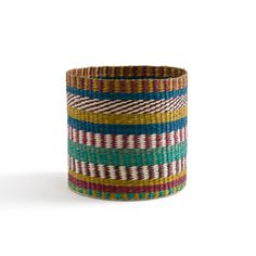 a multicolored striped basket on a white background