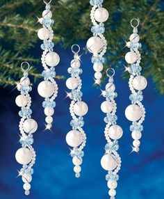 three ornaments hanging from a christmas tree with blue and white decorations on it's sides