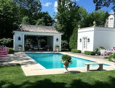 a backyard with a pool and patio furniture