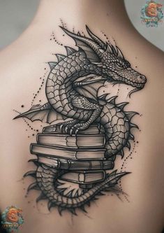 a woman's back with a dragon on top of books