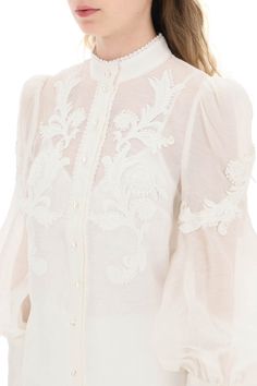 Zimmermann button-up blouse in linen silk organza, embellished with floral appliques and tonal beaded trimmings. Detailed with pearl-shaped buttons, it features a Mandarin collar, bouffant sleeves with long zip cuffs, and a removable jersey camisole with adjustable straps. The model is 177 cm tall and wears a size 1 Zimmermann. Size Info STANDARD Color Detail White Made In China Material 52%LI 48%SE Season One spring Season Two summer Product clothing Brand Zimmermann Size And Fit Elegant Tops With Embroidered Cuffs, Luxury Long Sleeve Embellished Blouse, Elegant Blouse With Embroidered Cuffs, Formal Long Sleeve Blouse With Embroidered Cuffs, Designer Long Sleeve Embellished Blouse, Elegant Fitted Tops With Embroidered Cuffs, Spring Formal Embellished Blouse, Elegant Tops With Intricate Embroidery For Spring, Spring Top With Embroidered Sleeves For Weddings