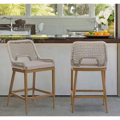 two wicker bar stools in front of an island