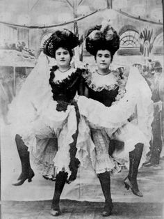 two women dressed in victorian clothing posing for the camera