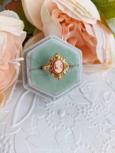 An enchanting cameo ring that features a classic portrait of a Grecian Goddess in a bezel setting. Resembling a kite-shaped shield, the ring face is decorated with ornate milgrain detailing. SIZE: This ring comes in your choice of size 6 or adjustable size, which is convenient if you aren't sure what size your recipient's finger is or if you like wearing rings on different fingers. Please note:  The aged gold only comes in adjustable size.  The aged silver comes in size 6 and adjustable size.  T Victorian Cameo, The Ring Face, How To Wear Rings, Cameo Earrings, Cardboard Jewelry Boxes, Historical Jewellery, Vintage Inspired Jewelry, Cameo Jewelry, Cameo Ring