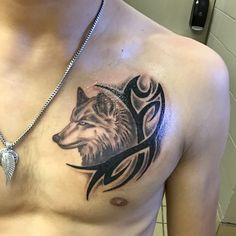 a man with a wolf tattoo on his chest