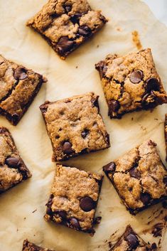 chocolate chip cookie bars are arranged on a piece of parchment paper