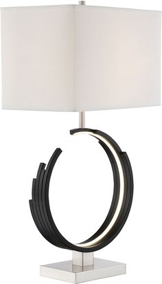 a table lamp with a white shade on it and a black ring around the base