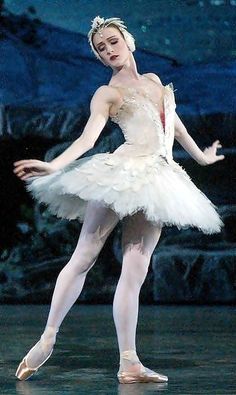 the ballerina is wearing a white tutu