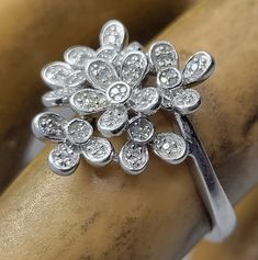 This is a gorgeous flower ring with white sapphire set in a 925 sterling silver boho forget me not setting East Village Bangles is the product of love ❤️, a unique collection of vintage jewelry painstakingly restored by Casey in the East Village. Even as we put love, sweat (and sometimes tears!) into restoring these items, it is our policy that you must be thrilled. We stand behind every item and we will take it back if it is not for you. Forget Me Not Ring, Ring Sapphire, East Village, Birthstone Gifts, September Birthstone, Flower Jewelry, Forget Me Not, Flower Ring, White Sapphire