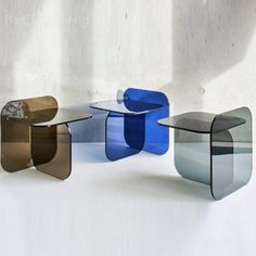 three different colored tables sitting next to each other