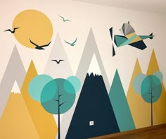 a wall with trees and birds painted on it