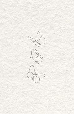 three butterflies flying in the air on top of white paper