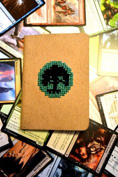 a book with beads on it surrounded by cards