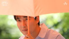 a man holding an umbrella over his head