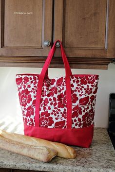 a red and white bag sitting on top of a counter next to a loaf of bread