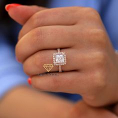 a woman's hand with a diamond ring on it