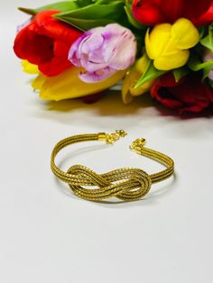 This simple yet elegant  gold infinity bracelet with lobster claw clasp is sure to allure. A symbol of the unbreakable pledge of love and devotion, the knot has been a simple yet elegant way of expressing commitment for centuries. This bracelet is made from Golden Grass and represents that timeless and binding love. With fluid lines and feminine curves, the Love Knot bracelet is adaptable and can fit mosts wrists.  > Variable length thanks to extension chain > Materials: * Made with Natural Gold Gold Party Bracelets With Lobster Clasp, Party Gold Bracelets With Lobster Clasp, Flexible Gold Bracelets For Party, Gold Infinity Shaped Metal Jewelry, Adjustable Gold Infinity Jewelry, Adjustable Infinity Gold Jewelry, Adjustable Gold Infinity Chain Bracelet, Gold Infinity Jubilee Bracelet, Gold Infinity Bracelets With Adjustable Fit