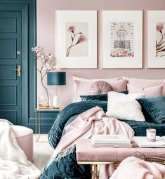 a bedroom with pink and blue walls, pictures on the wall and bed in it