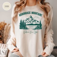 Adirondack Mountains Grunge Style Camping Shirt, Adirondacks Comfort Colors® Long Sleeve T-Shirt, Adirondack Hiking Tee, Nature Lover Shirt.  Orders are processed within 24 hours and shipped out within 2 to 5 business days. What you receive Comfort Colors® Adult Unisex Long Sleeved Crewneck T-shirt Color Choices: Ivory Light Green Blue Jean Pepper Crimson Berry Sizes: Unisex adult sizing use size chart as a guide. These shirts are fitted and run true to size. If you prefer a loose fit go one size larger. If you want an oversized tee consider even 2 sizes larger. Shirt Details: Comfort Colors introduces its garment-dyed t-shirt; a fully customizable tee made 100% with ring-spun cotton. The soft-washed, garment-dyed fabric brings extra coziness to your wardrobe while the relaxed fit makes it Adirondack Mountains, Vacation Shirts, Grunge Style, Camping Shirt, Oversized Tee, Blue Jean, Grunge Fashion, Dye T Shirt, Shirt Color