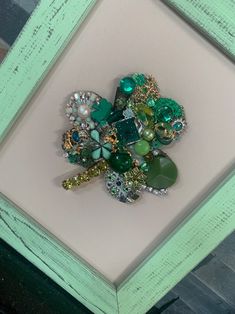 a close up of a brooch in a frame