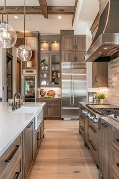 a large kitchen with wooden cabinets and marble counter tops, along with stainless steel appliances