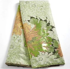 two napkins with green and orange flowers on them