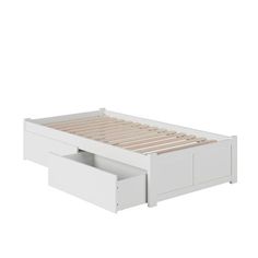 a white bed with drawers underneath it