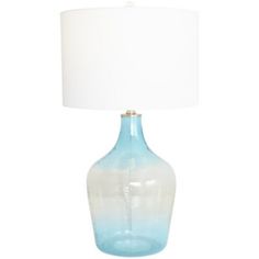 a blue glass table lamp with a white shade