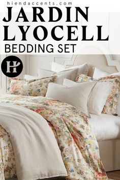 a white bed with floral comforter and pillows