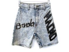 "Vintage 80's Banda Macho graphic denim acid wash shorts. Fitted and stretchy cut with faux leather graphics. Every garment we sell is authentic vintage and one-of-a-kind! You will receive the exact item photographed. Condition: Very good vintage. Best fits women's: Labelled 5/6 Extra small Material: denim MEASUREMENTS Taken from seam to seam while the garment is lying flat. Double the armpit, waist, and hips Waist 24\" Waist to hem 17\" Hips 16.5\" Crotch to waist 11.5\" Leg opening 9\"" Red Lace Blouse, Lace Bustier Top, Acid Wash Shorts, Corsets Vintage, 70s Shirts, White Lace Mini Dress, Grunge Dress, Backless Blouse, Vintage Crop Tops